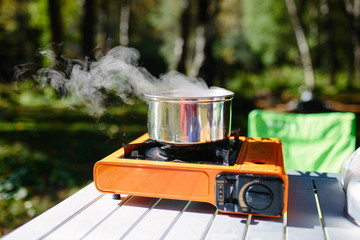 The pot stands on a portable gas burner in the tourist camp