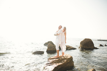 Fashion model couple with tattoo posing outside nea sea