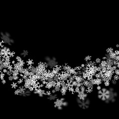 Snowfall background with snowflakes blurred in the dark