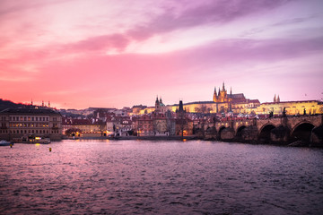 Fototapeta na wymiar Panoramic View of Prague Castle, Charles Bridge and St Vitus Cathedral reflected in the Vltava river at dusk - Prague - Czech Republic