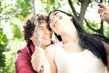 Smiling Couple on a Swing