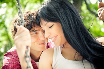 Smiling Couple on a Swing