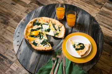 Pizza, juice in glasses and dishes on the round table. Home Interior, the author's processing