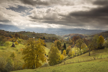 Fototapeta na wymiar Autumn landscape hills in Romania County, traditional village