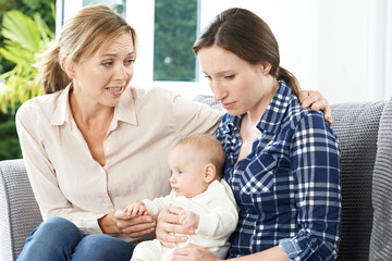Mother Comforting Adult Daughter Suffering With Post Natal Depre