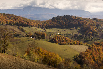 Autumn landscape hills in Romania County, traditional village