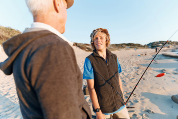 Fototapeta premium Senior man fishing with his grandson