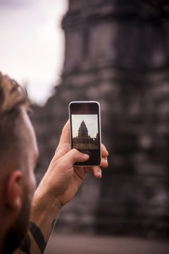 Indonesia, Java, Tourist photographing Prambanan temple