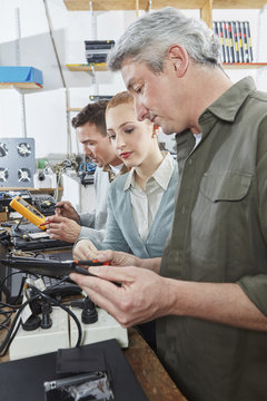 People working in workshop of computer recycling plant