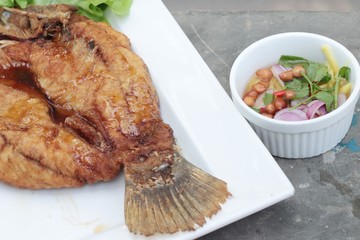 Fried snapper with fish sauce and spicy salad.
