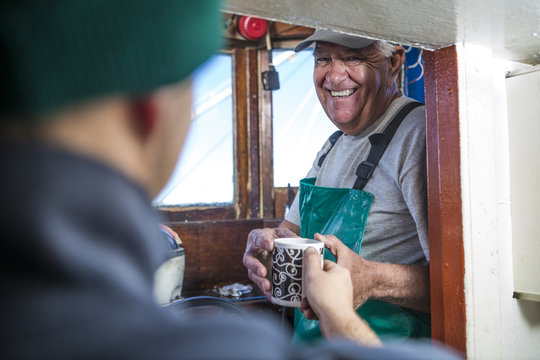 Fisherman Getting Cup Of Coffee