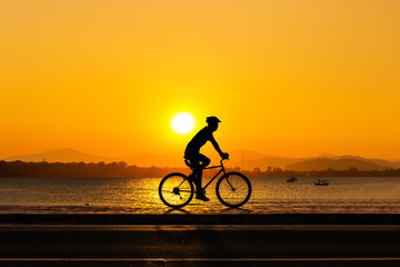 Naklejka na ściany i meble Man cycling at beach