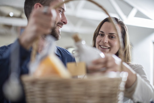 Happy couple with food hamper in farm shop