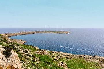 Sea cliff with green grass and buggy road