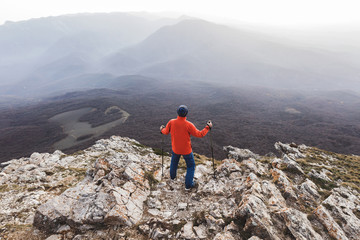 Man standing on top of rock and looking at the silhouettes of th