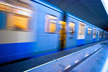 Fast riding a train in the subway station