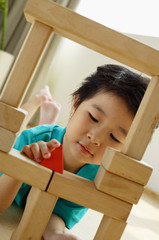Young girl playing with building blocks