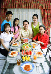 Three generation family around dining table, portrait