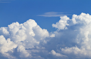 Cumulus white clouds in the blue sky