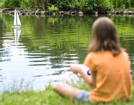 Girl with remote controlled boat