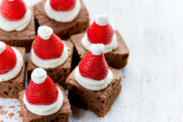 Santa Hat Brownie Bites with strawberries and whipped cream