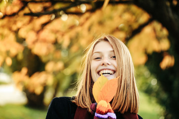 Pretty girl with autumn leaves