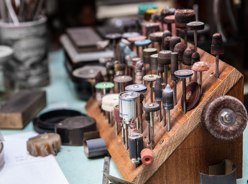 A lot of dremel bits at jeweler's workplace
