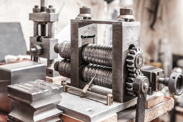 Rolling press tool in jeweler's workroom