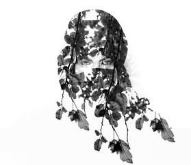 Monochrome double exposure of woman wearing burqa and leaves