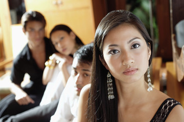 Woman looking at camera, people in the background