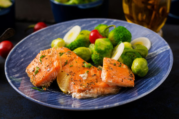 Baked salmon fish garnished with broccoli and Brussels sprouts with leek. Fish menu.