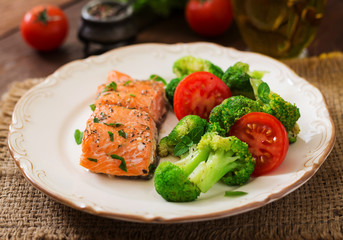 Baked fish salmon garnished with broccoli and tomato. Dietary menu. Fish menu. Seafood - salmon.