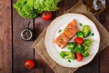 Baked fish salmon garnished with broccoli and tomato. Dietary menu. Fish menu. Seafood - salmon. Top view