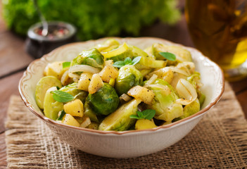 Stewed Brussels cabbage sprouts, apples and leeks in bowl. Dietary menu.
