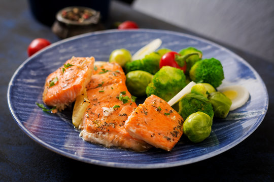 Baked salmon fish garnished with broccoli and Brussels sprouts with leek. Fish menu.
