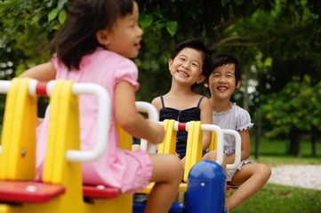 Three girls on a seesaw