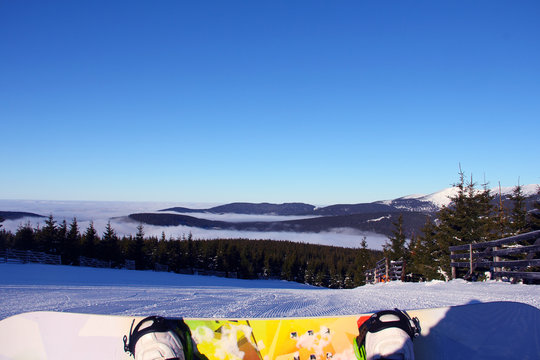 Snowboarder sitting on slope