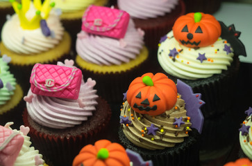 Fancy halloween cupcakes with pumpkins, pink Chanel bags and crowns