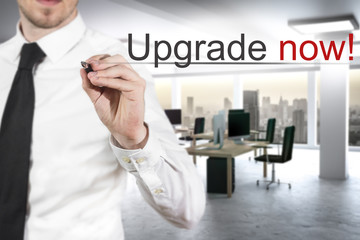 businessman writing upgrade now in the air