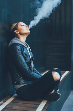 Young woman smoking Electronic Cigarette.