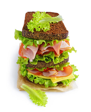 Sandwich with rye bread, ham, tomato, cheese and lettuce
