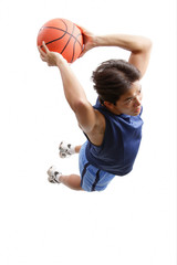Young man holding basketball, jumping, preparing to shoot © Alexander