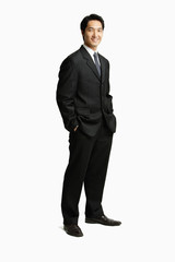 Obraz na płótnie Canvas Businessman standing, hands in pocket