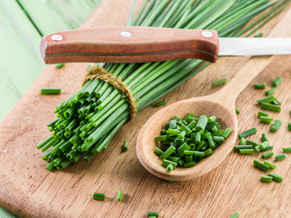Green onion on the wooden table.