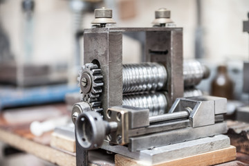 Rolling press in jeweler's workroom