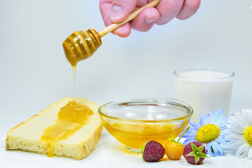 Honey dripping on a fresh slice of bread