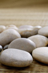 Fototapeta na wymiar Close up of pebbles on a Tatami mat