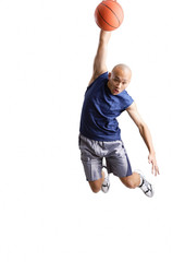 Young man making a slam dunk with basketball