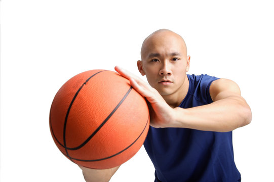 Young man holding basketball, towards camera