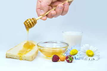 Honey dripping on a slice of fresh bread